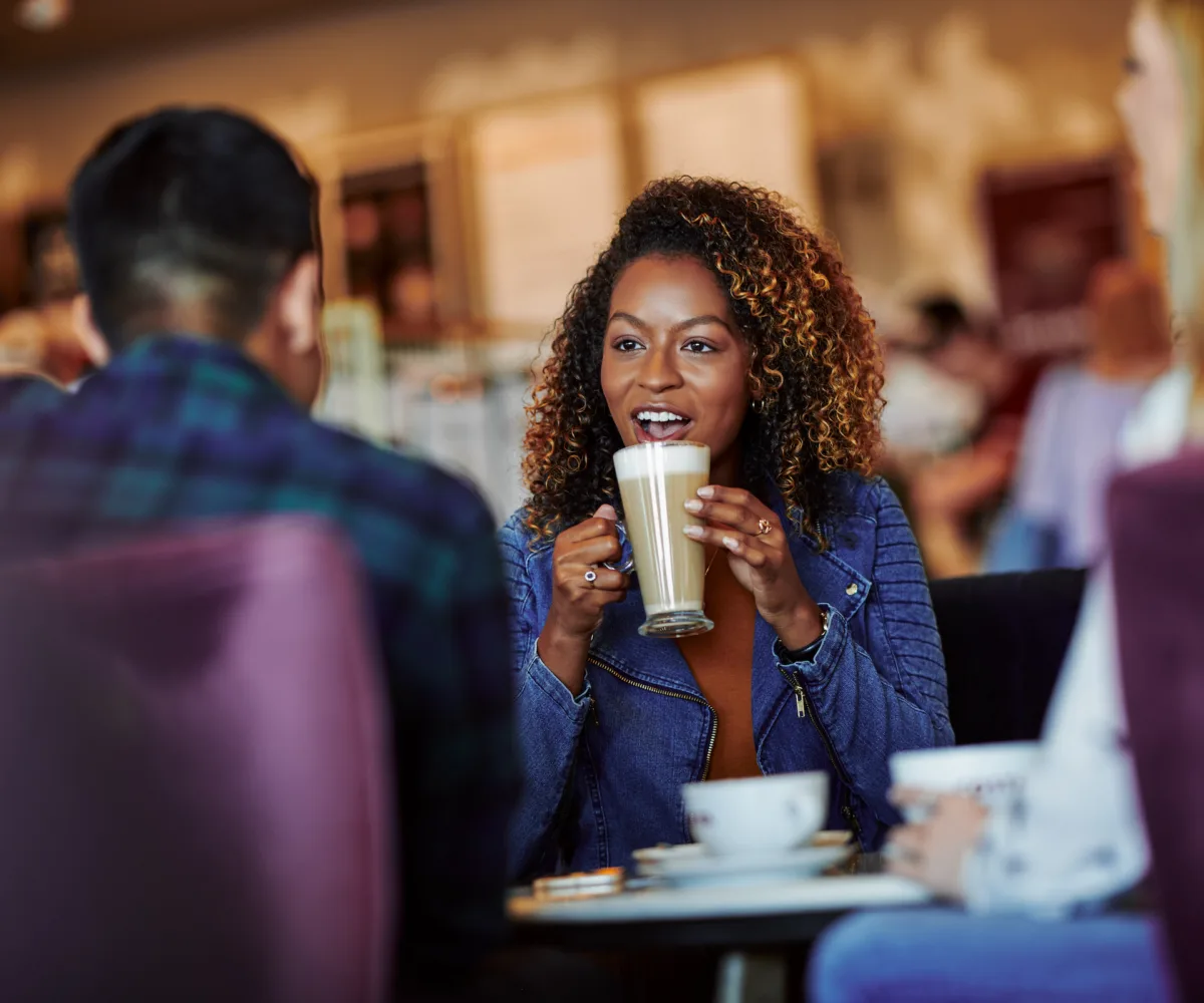 Costa Coffee Customer holding hot coffee and talking