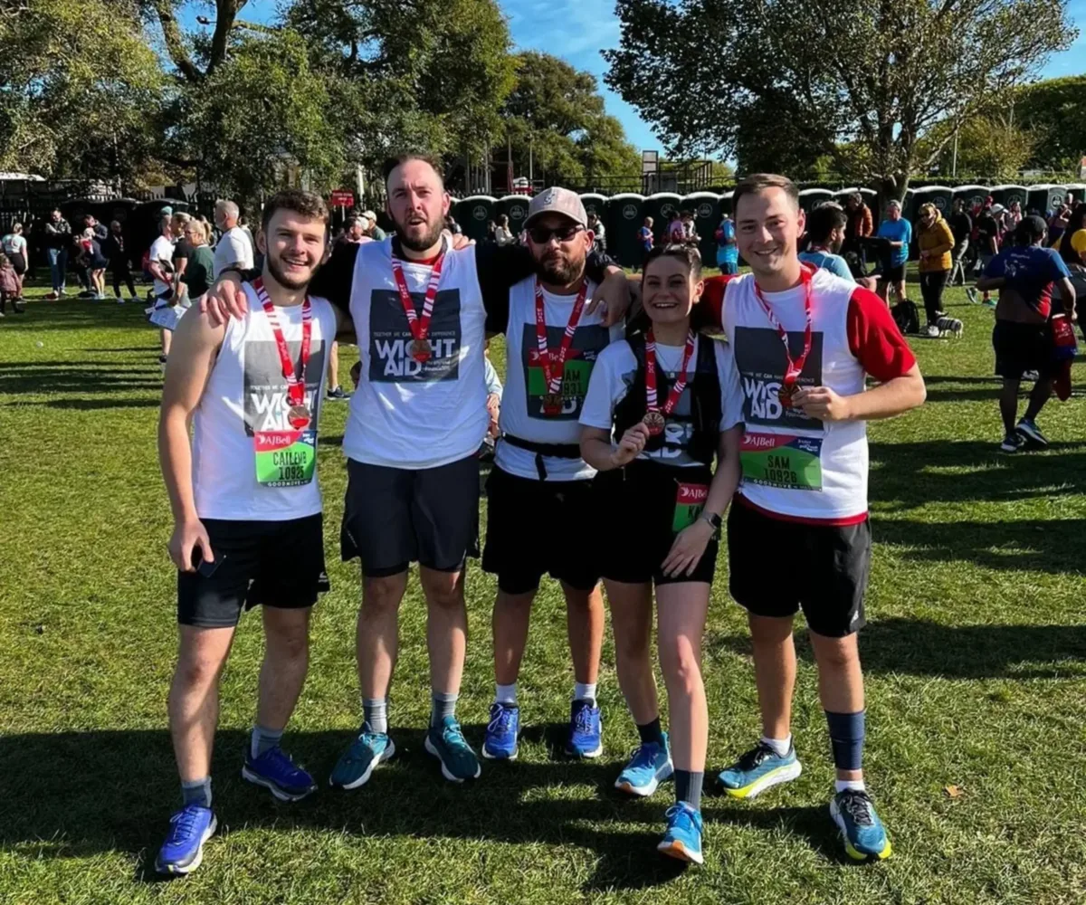 Five WRS Systems employees with medals after completing the Great South Run in 2023