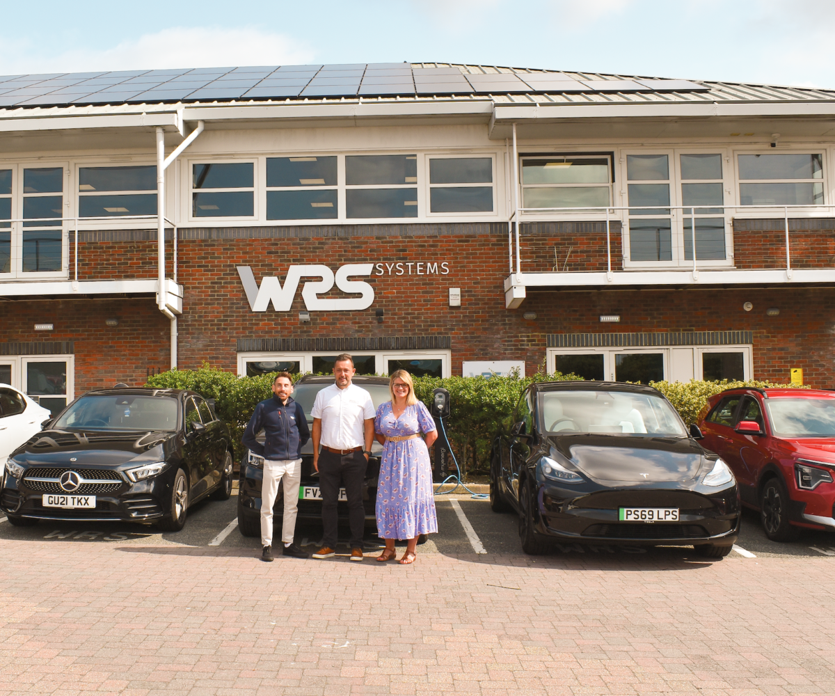 WRS Team member with electric cars alongside Nancy and Paul Thorley from Vehicle Consulting
