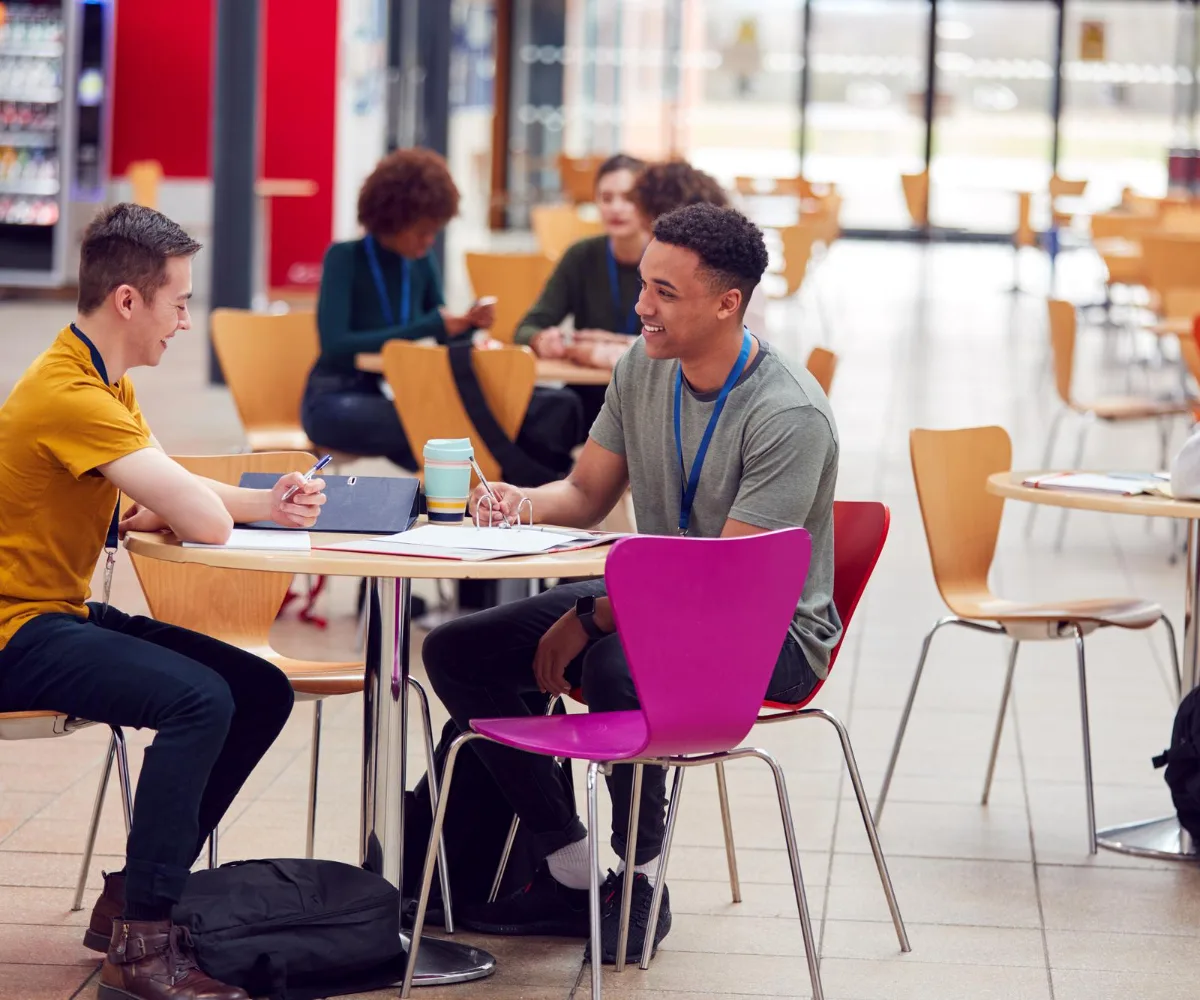communal area college campus with students working on tables