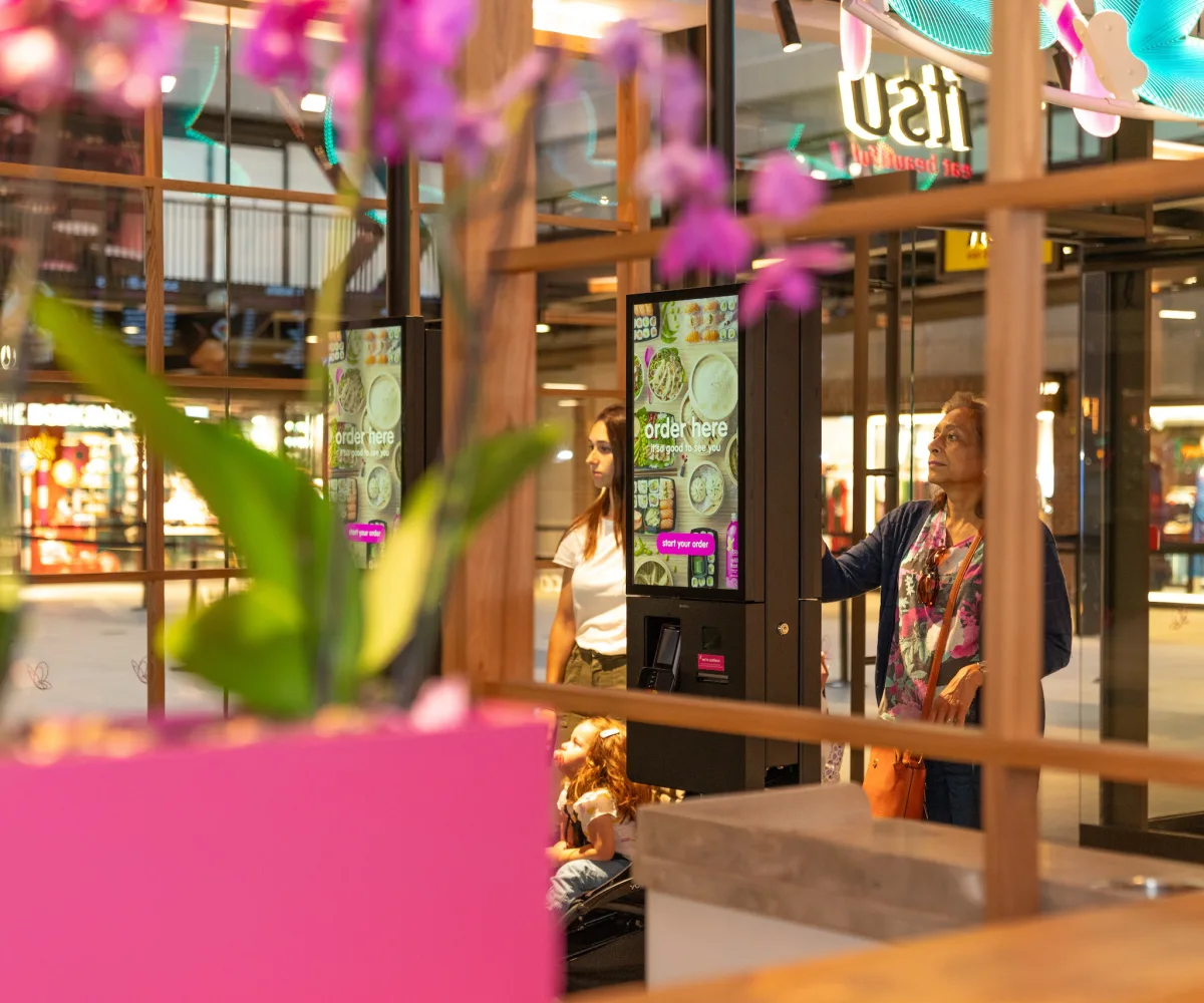Point of Sale System being used by customers in an itsu store, self-service kiosks