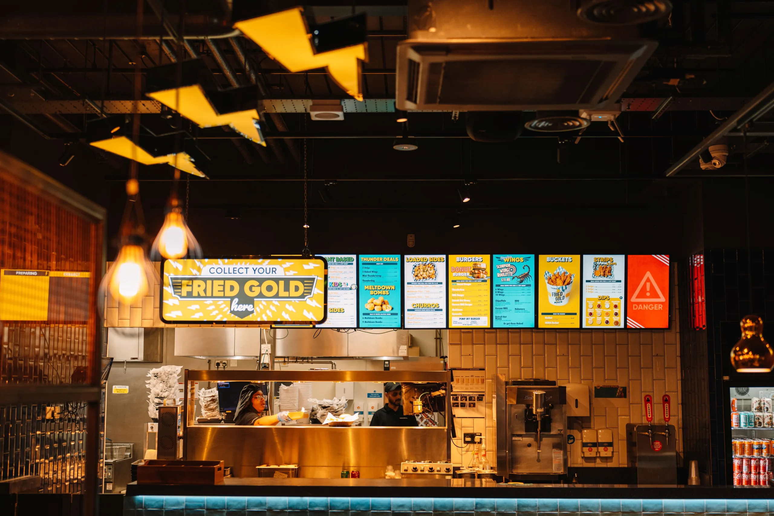 Digital menu screens and service counter in a hospitality venue